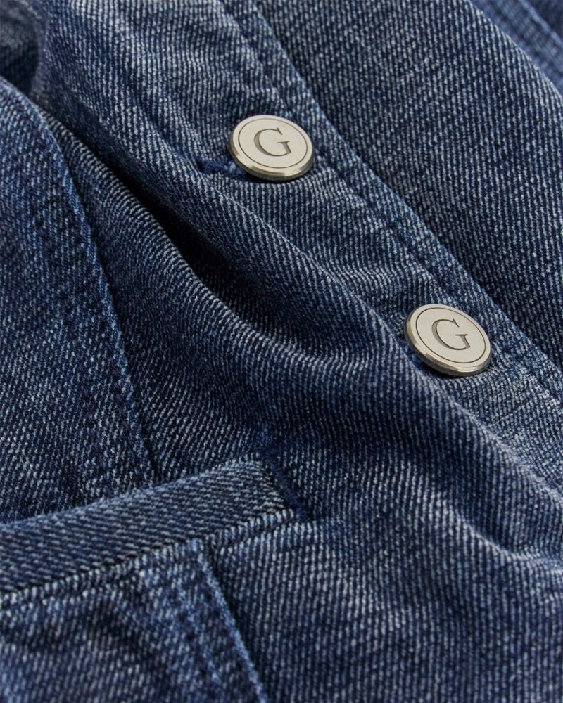 Close up of button detail on Guess dark wash denim vest