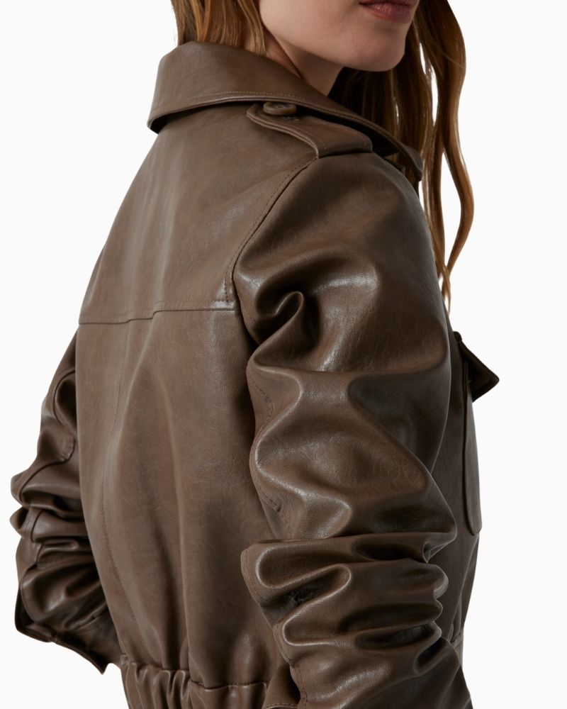 Side view of Guess cropped faux leather jacket in brown with collar and flap pockets