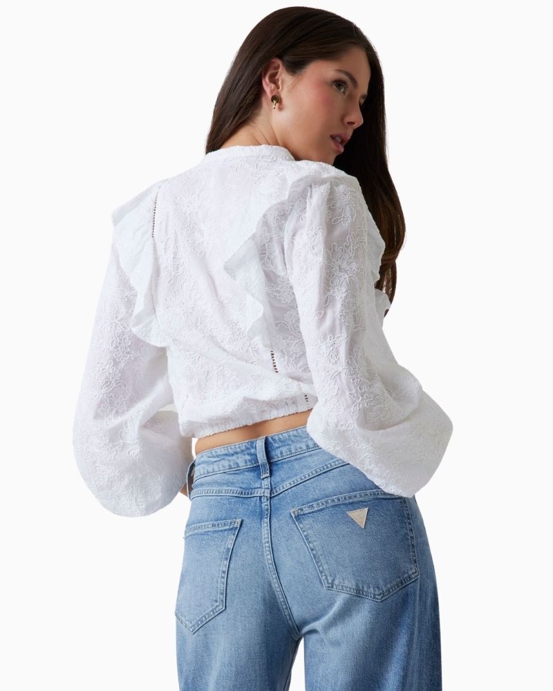Back of Guess white cotton blouse with floral embroidery and ruffled shoulders