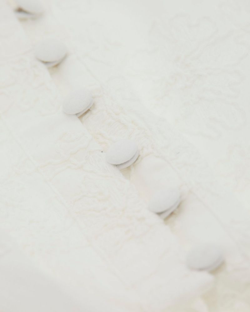 Close up of Tie-front cropped blouse with long sleeves and button-down front