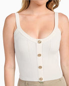 Close up of GUESS white knit crop tank with scoop neck and tie-back detail