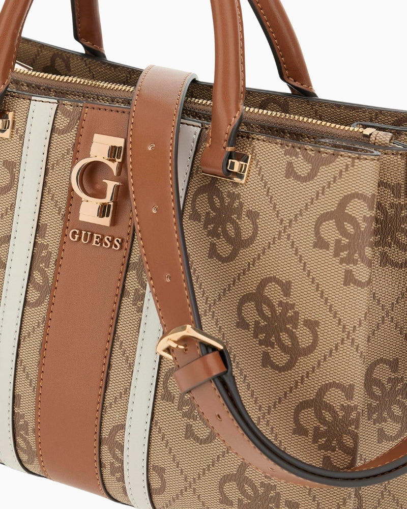 Close-up of detachable charm and pale gold hardware on Erenia handbag