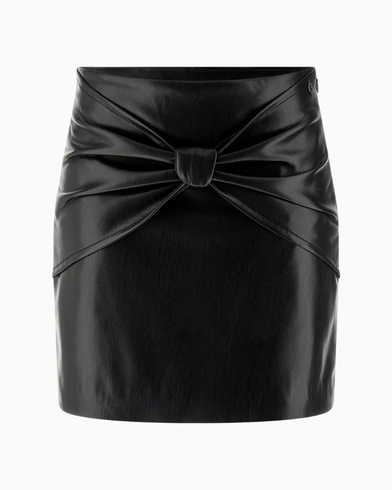 Front view of black gloss mini skirt with bow detail and fitted waist