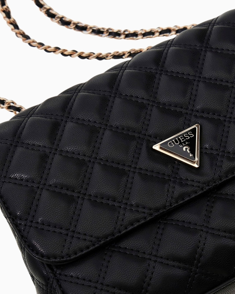 Close-up of flap and pale gold hardware on Guess Giully quilted crossbody bag