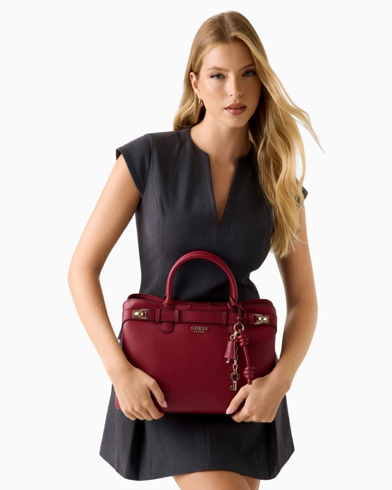 Front view of structured red handbag with twin handles and zip closure