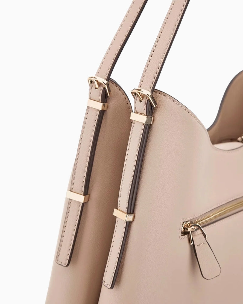 Close‑up of Guess branding detail and stitching on taupe Guess shoulder tote
