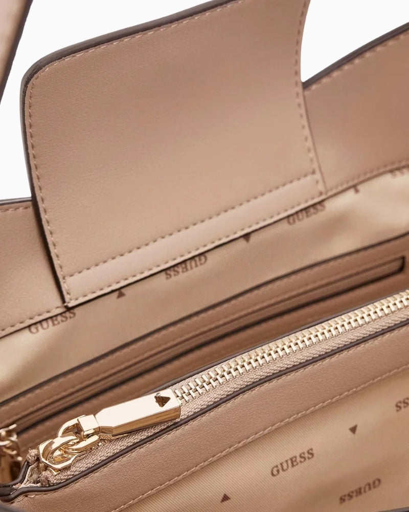 Close‑up of Guess branding detail and stitching on taupe Guess shoulder tote