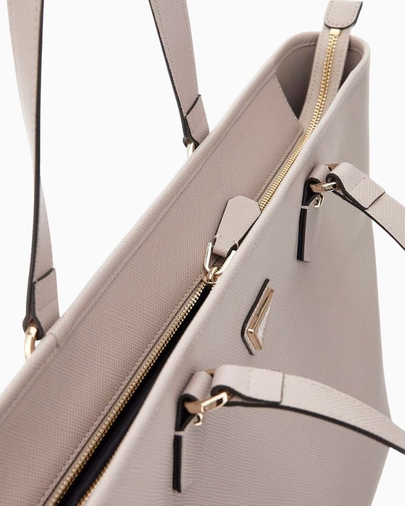 Inside view of GUESS tote showing laptop sleeve and spacious interior