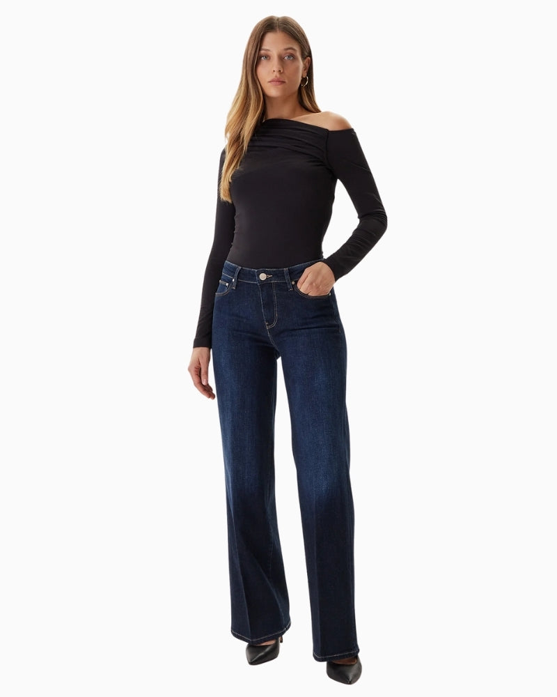 GUESS trousers styled with blouse and heels, showing full-length drape