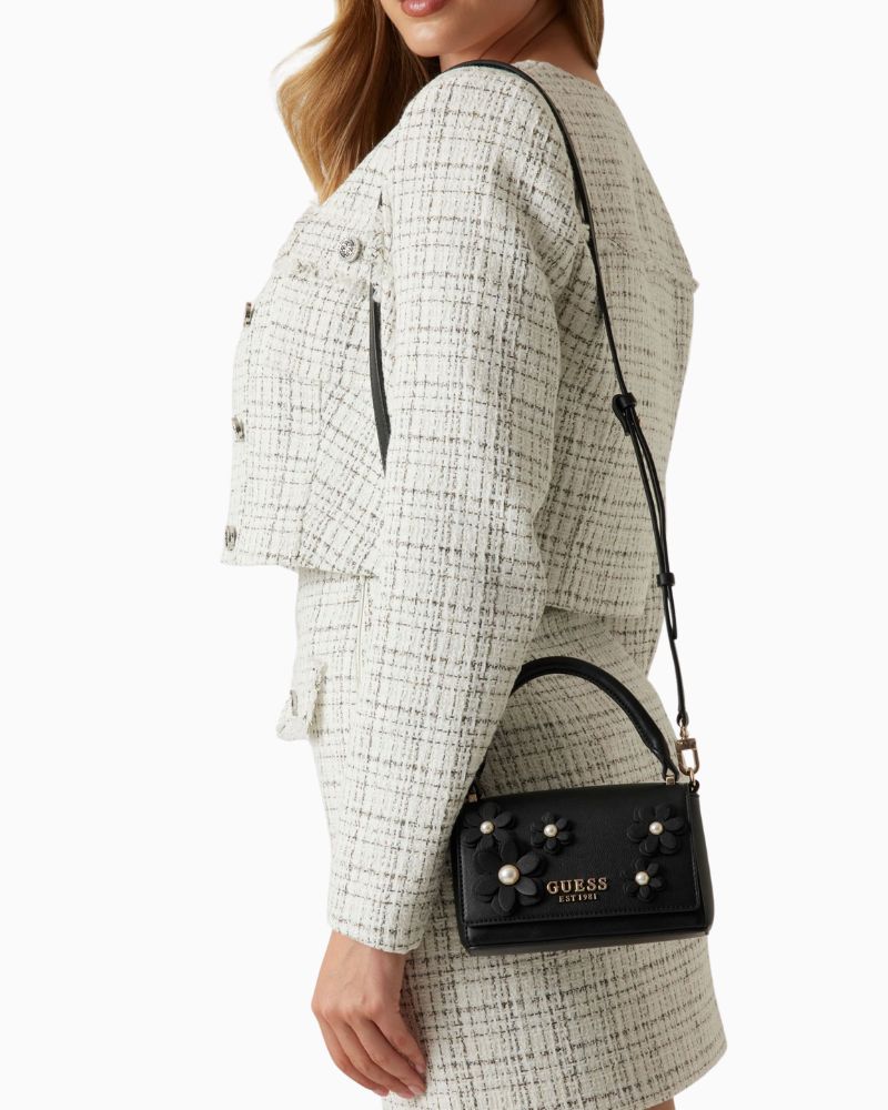 Front view of mini handbag with gold logo and flap closure