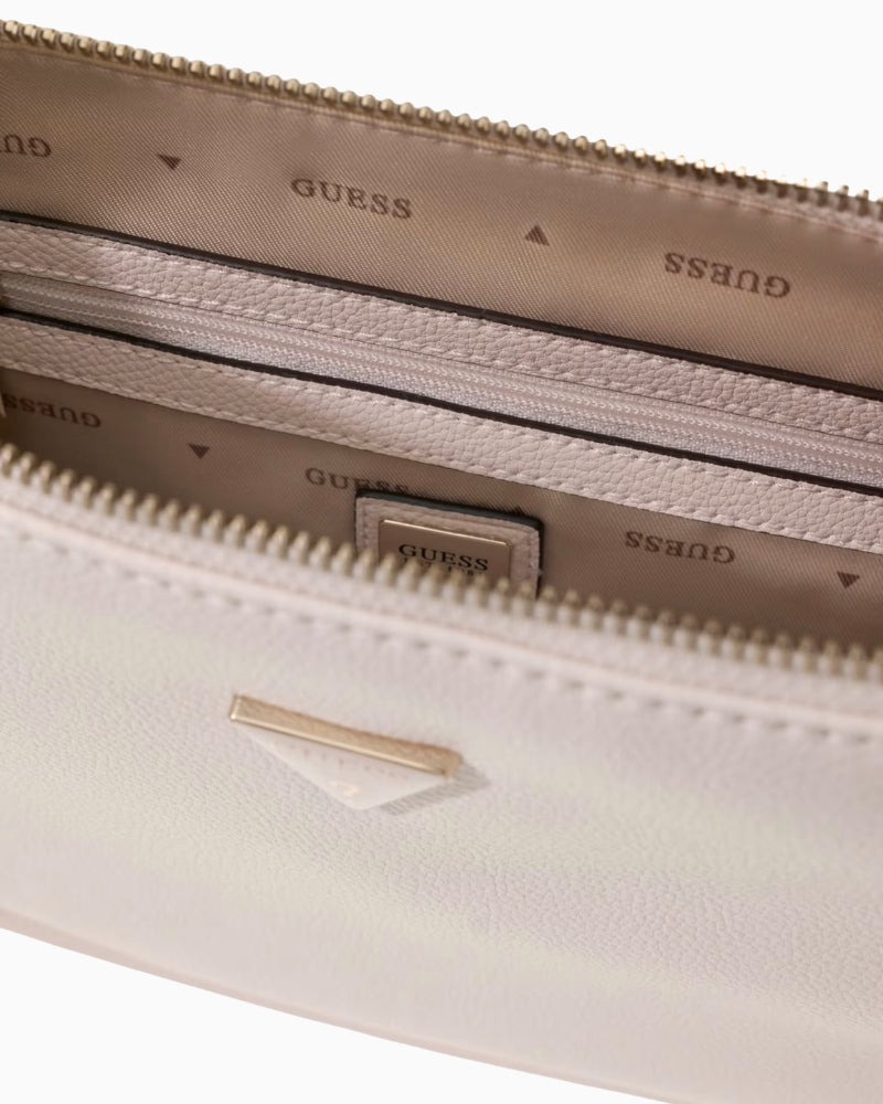 Close-up of Guess Danya handbag interior with logo lining and zip pocket detail – Áines Boutique