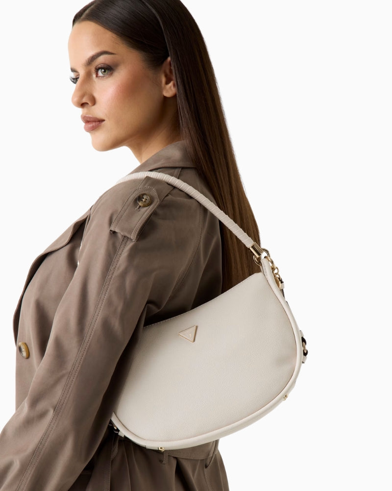 Woman wearing Guess Danya faux leather shoulder bag, side view – Áines Boutique
