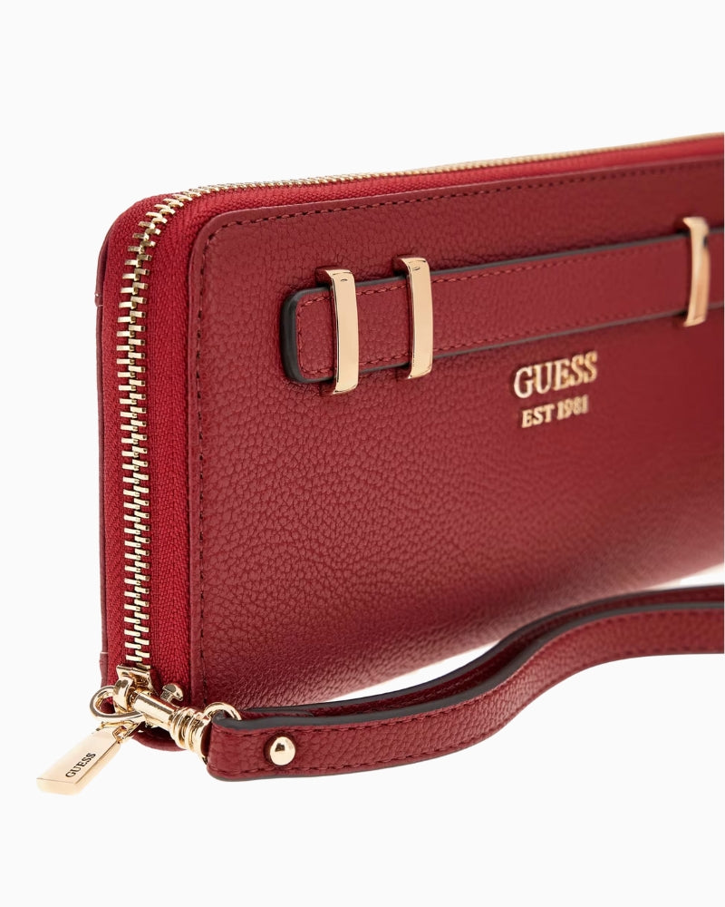 Close-up of detachable zipper pull and pale gold hardware on Guess wallet