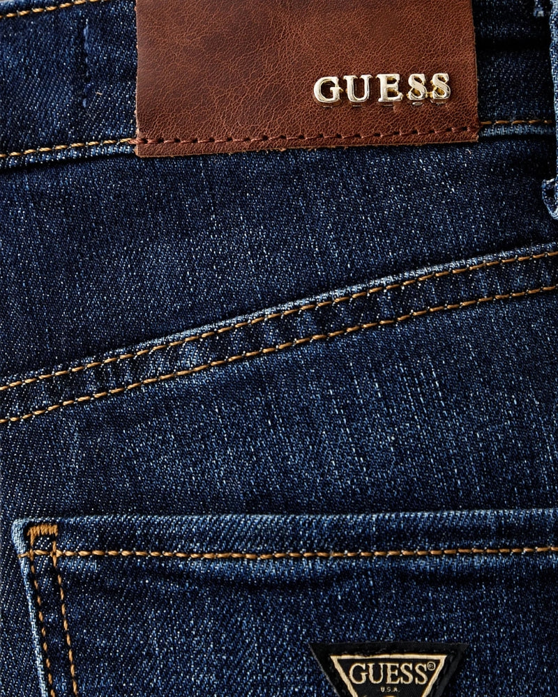 Guess Sexy Straight Jeans in Dark Denim logo patch detail