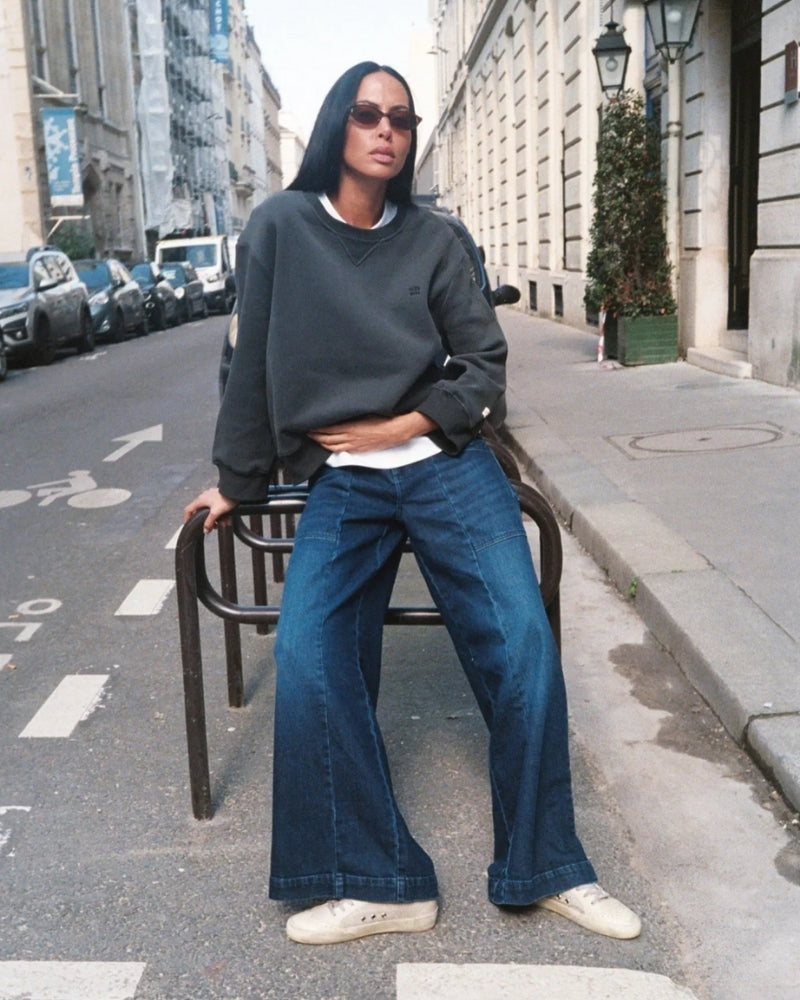 Front view of mid-rise jeans with double-button waist and large pockets