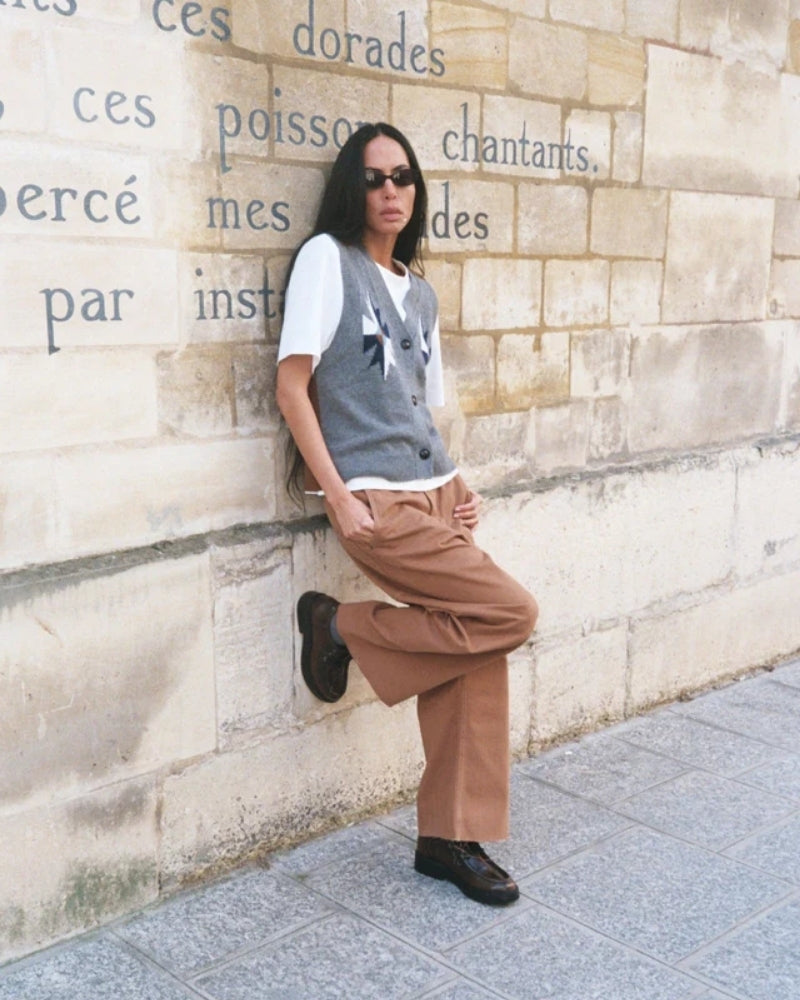 Styled knit vest layered over a shirt with relaxed fit