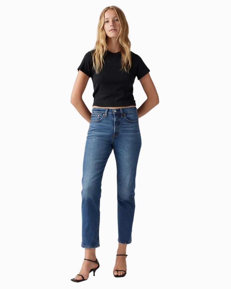 Model view of Straight leg high-rise jeans by Levi’s in faded blue stretch denim with button fly