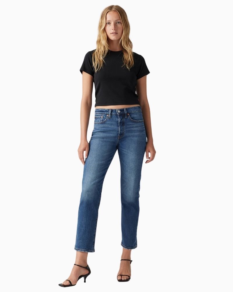 Model view of Straight leg high-rise jeans by Levi’s in faded blue stretch denim with button fly