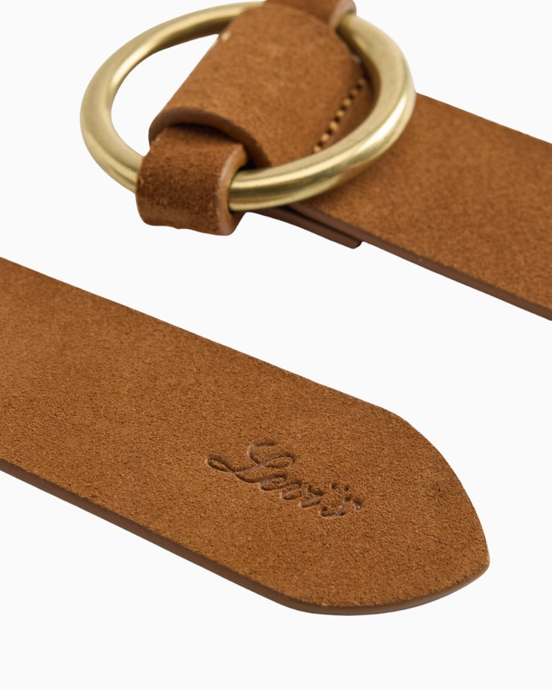 Close-up of round metal buckle and smooth leather texture on Levi’s belt