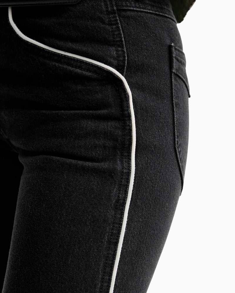 Close-up of waistline and button closure on Levi’s Wedgie Boot Piping jeans