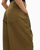 Close-up of metallic logo at belt loop on Lola Casademunt trousers