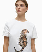 Close-up of sparkling tiger design on white cotton fabric