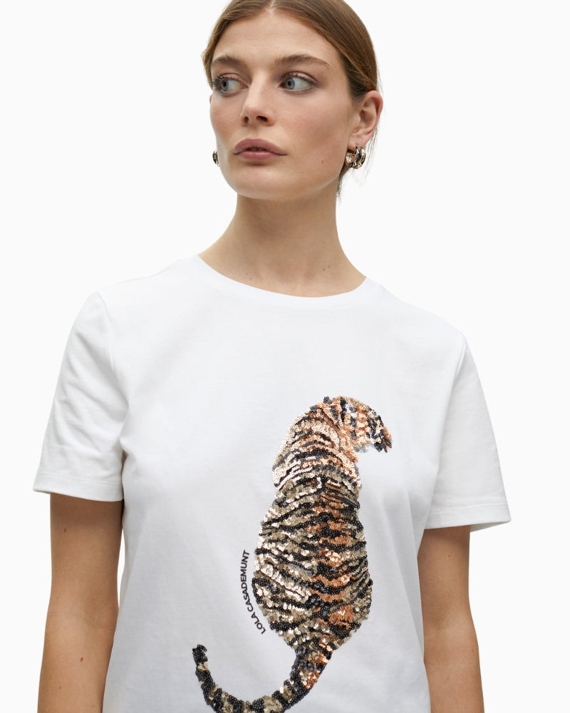 Close-up of sparkling tiger design on white cotton fabric