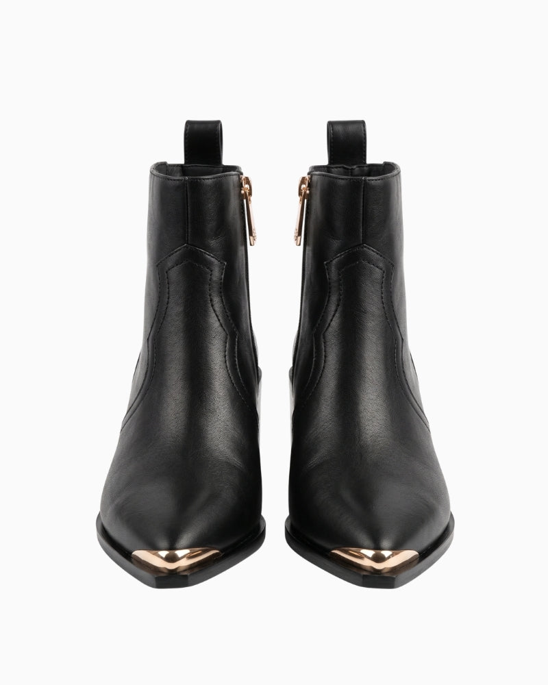 Lola Casademunt Cowboy Ankle Boot W/Studs in black front view with pointed gold-tone toe caps