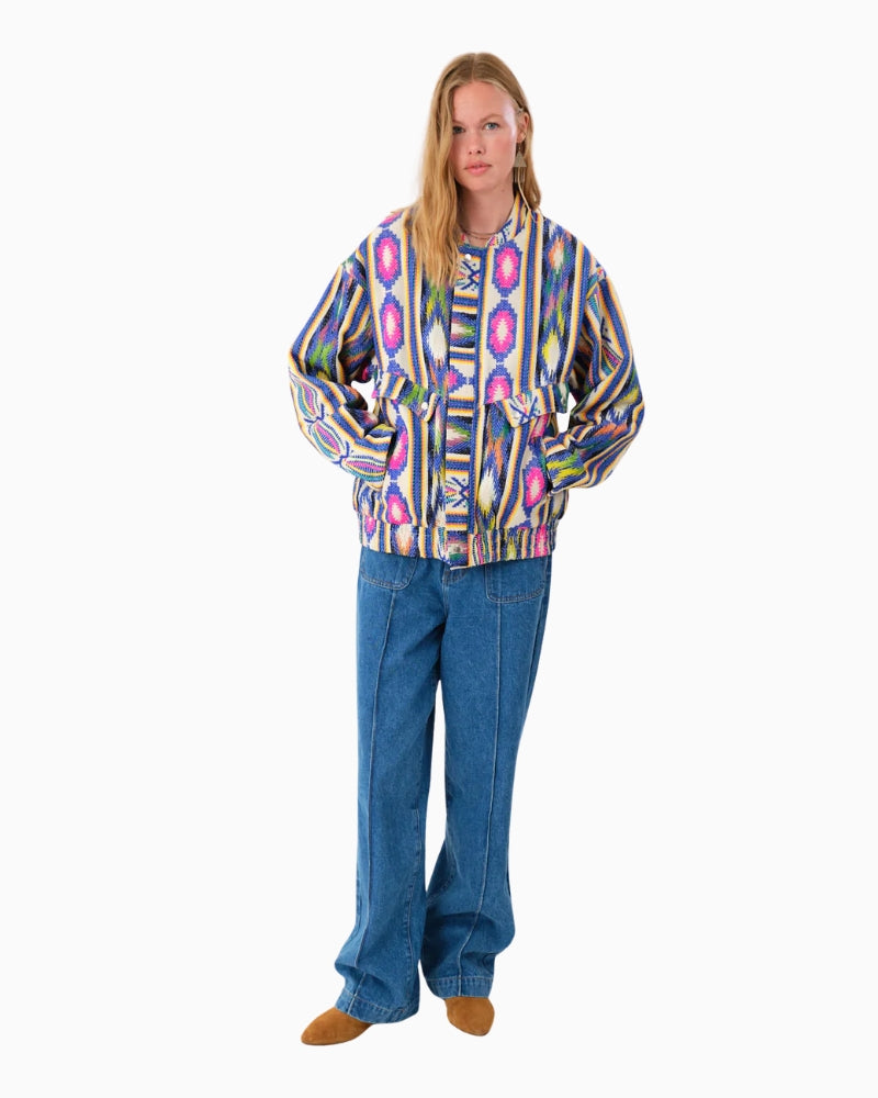 Model wearing oversized bomber jacket with hands in side pockets