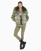 Front view of Marc Aurel shimmer puffer jacket with faux fur hood and zip pockets