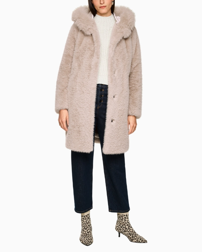 Marc Cain hooded winter coat styled over jeans and knit for a cosy look