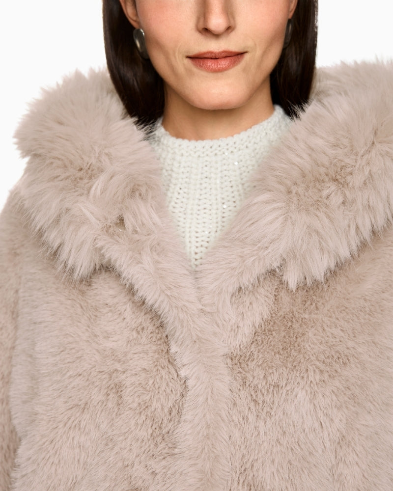 Close-up of soft faux fur texture and hood detail on Marc Cain coat
