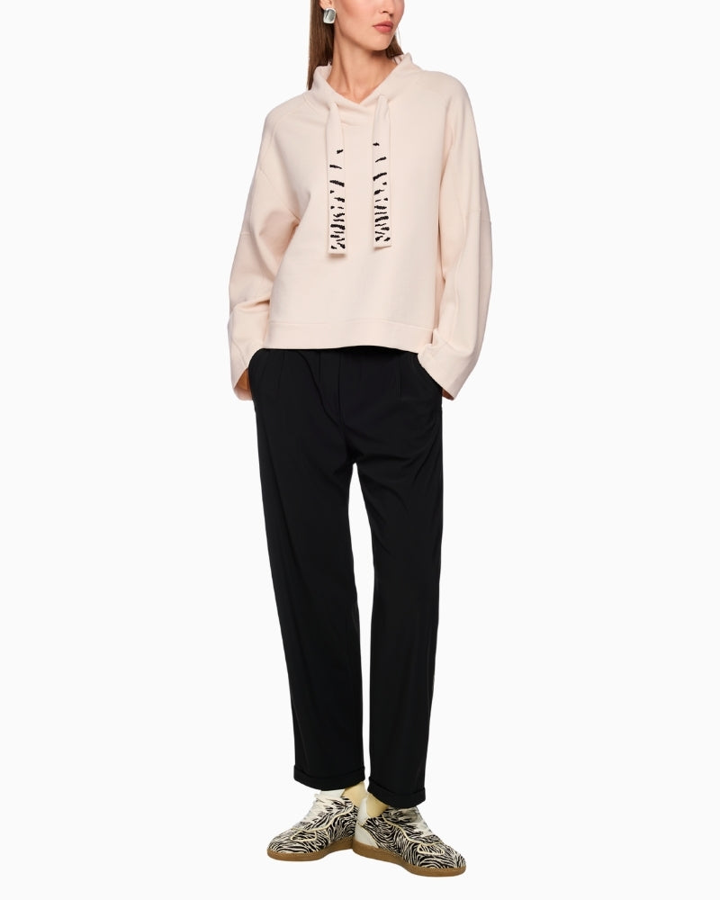 Cream sweatshirt by Marc Cain styled with slim black jeans