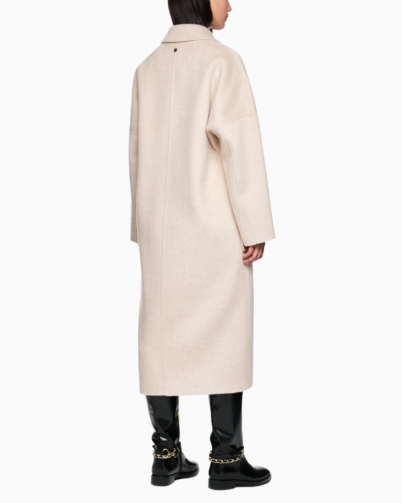 Back view of long wool coat showing wide silhouette and natural drape