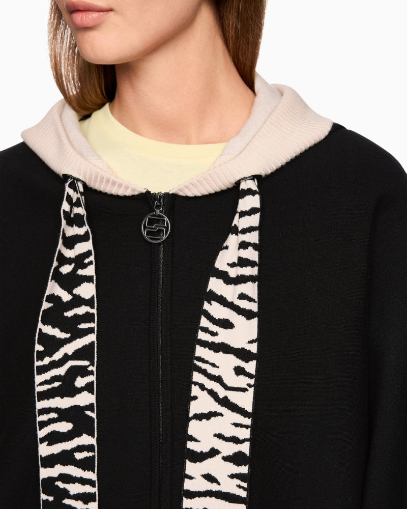 Close-up of animal print trim and bold stripe on hood