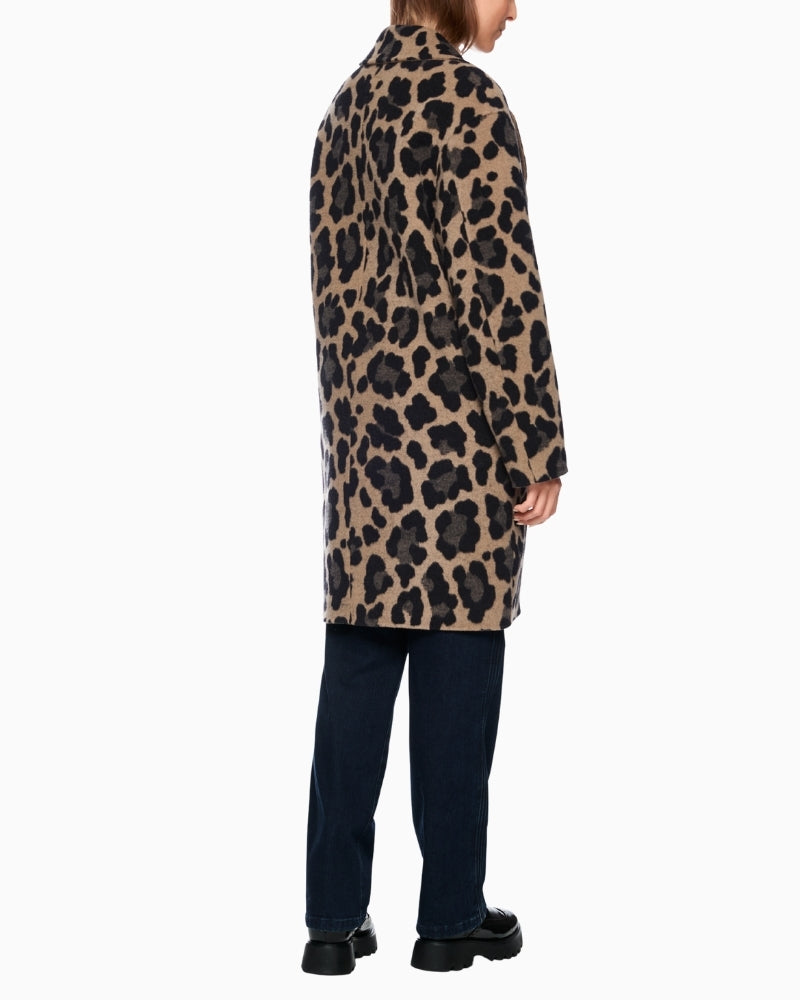 Back view of beige side of coat showing clean, straight fit and open pockets