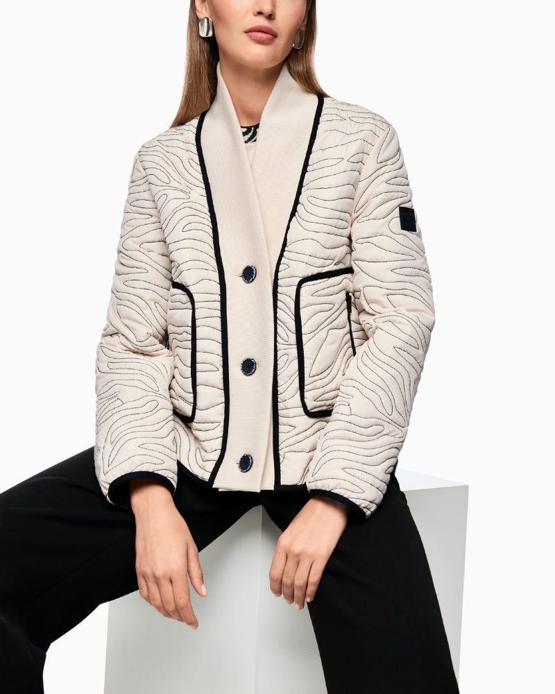 Front view of boxy short jacket with ribbed knit collar and button fastening