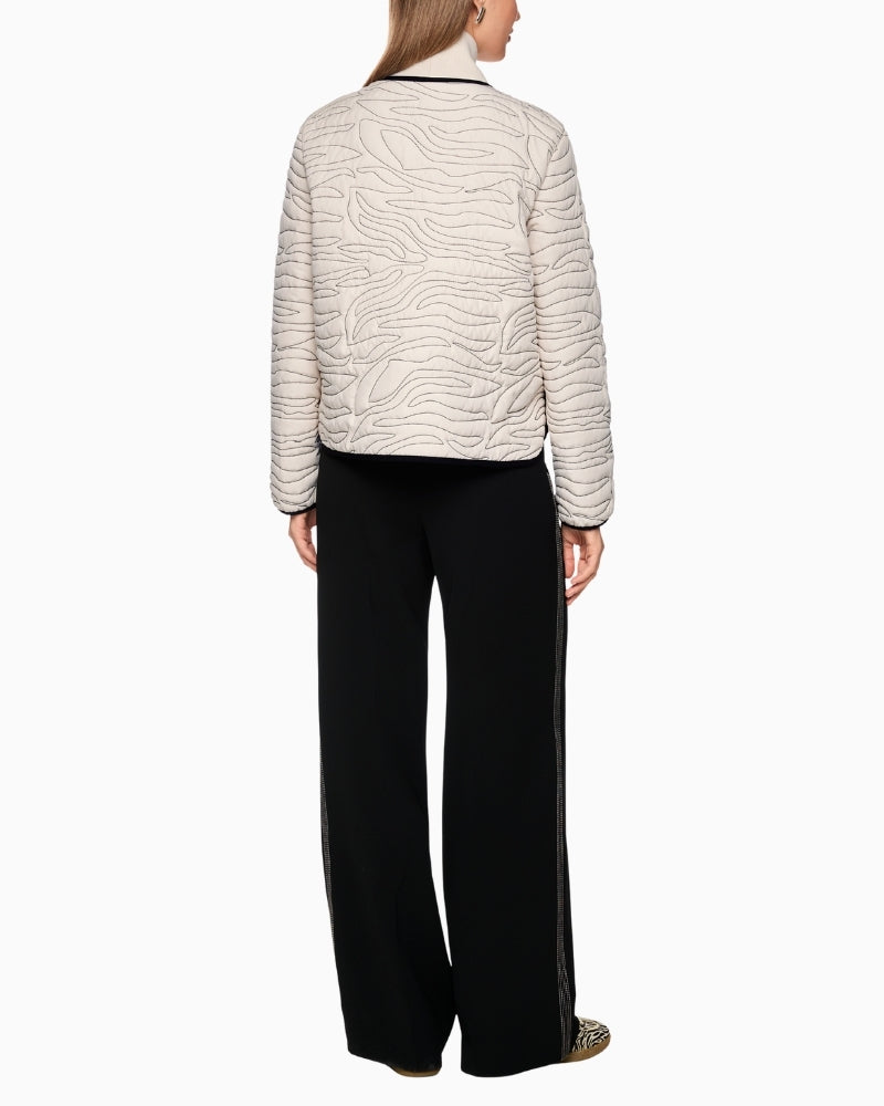 Back of short quilted jacket showing contrast seams and structured shape