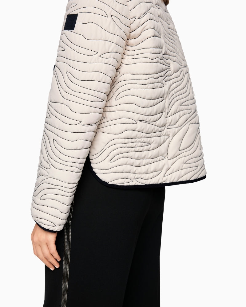 Close-up of zebra print buttons on Marc Cain cream jacket