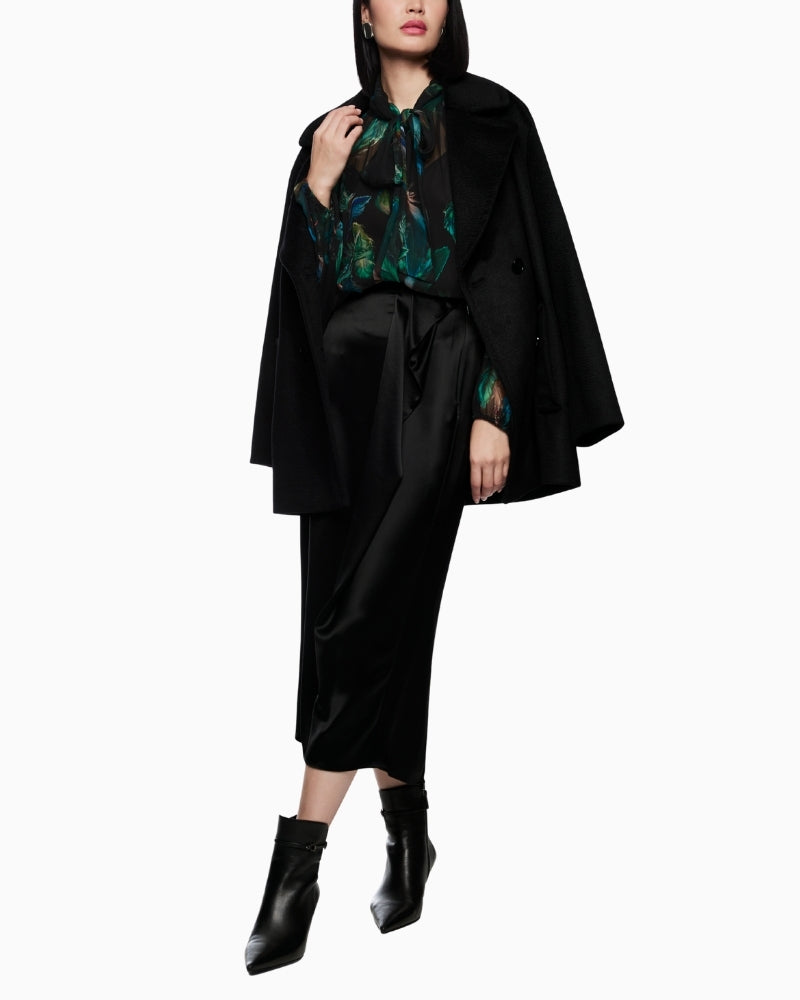 Sheer feather-print blouse by Marc Cain with bow tie neckline and loose fit