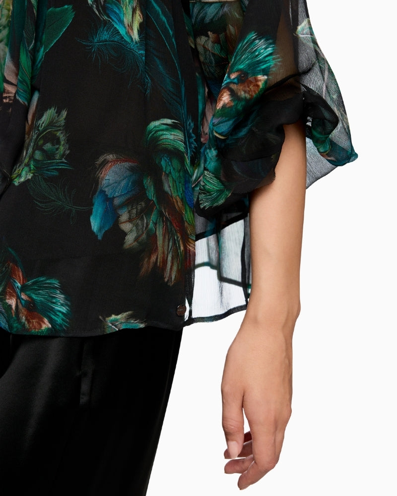 Close-up of feminine bow detail on Marc Cain’s airy viscose blouse