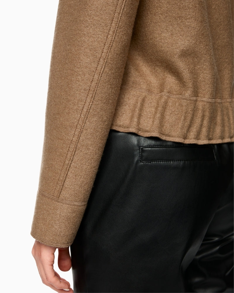 Close-up of quilted patch pocket and textured wool fabric