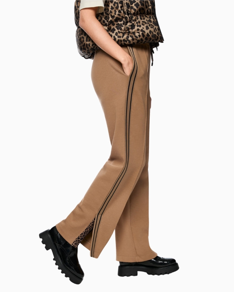 Side view of wide cut Marc Cain trousers showing slit hem and elongating stripe