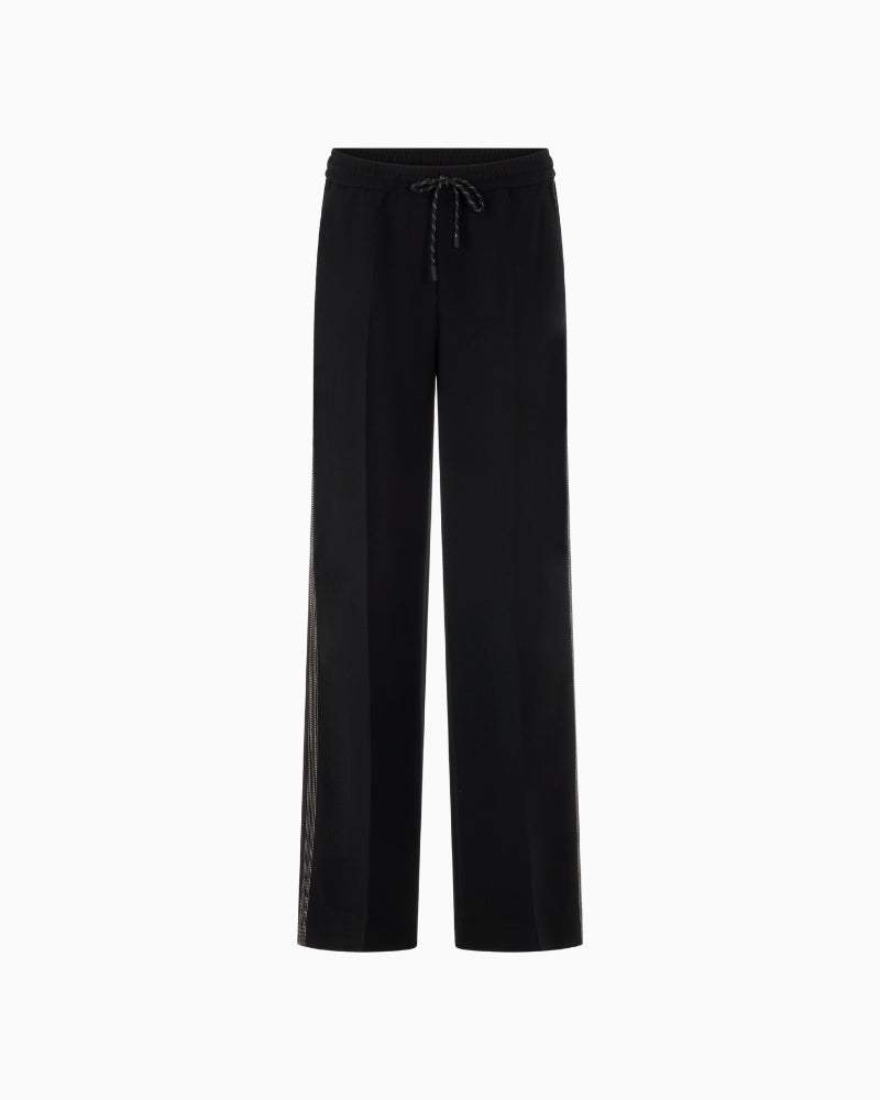 Front view of extra-long wide trousers with crease detail and drawstring waist
