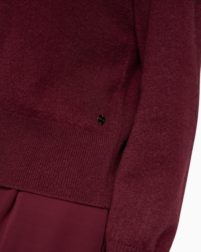 Detail of soft cashmere knit texture in rich maroon hue