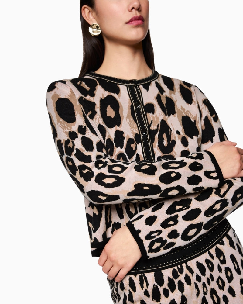 Sleeves and hem detail of cropped cotton cardigan in neutral tones