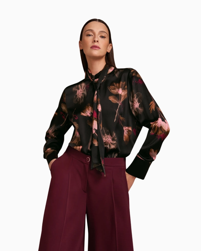 Styled outfit featuring black floral blouse tucked into trousers
