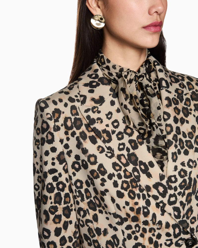 Close-up of leopard print fabric texture and button detail