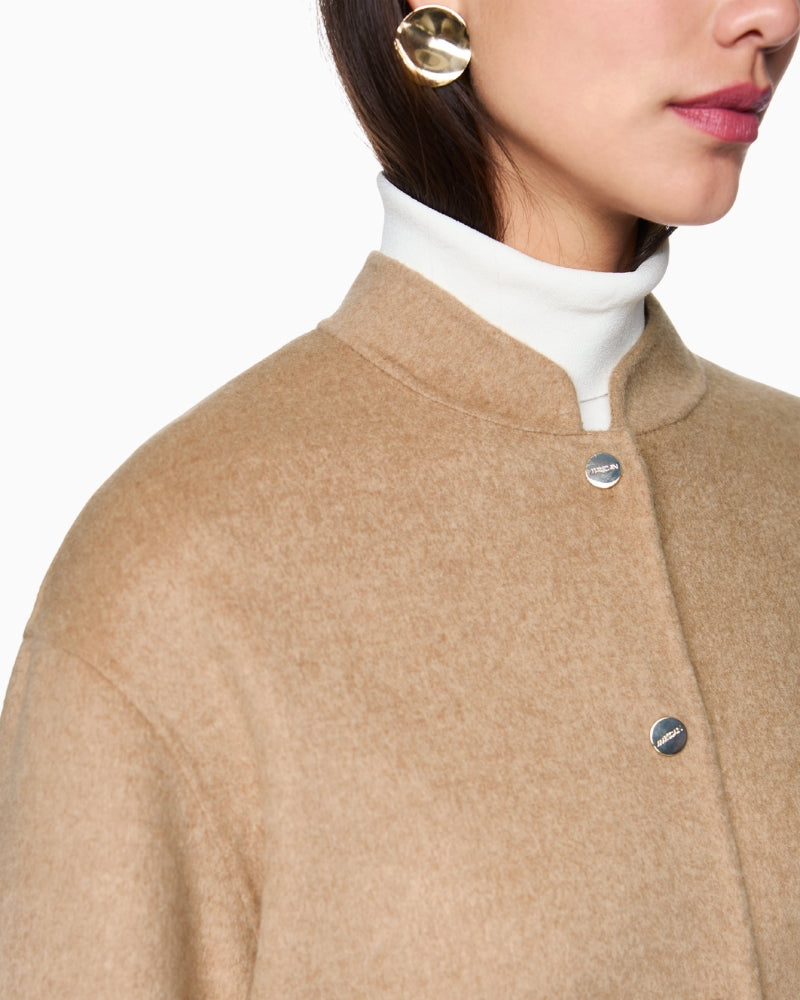 Close-up of cuffed sleeve detail on Marc Cain sand jacket