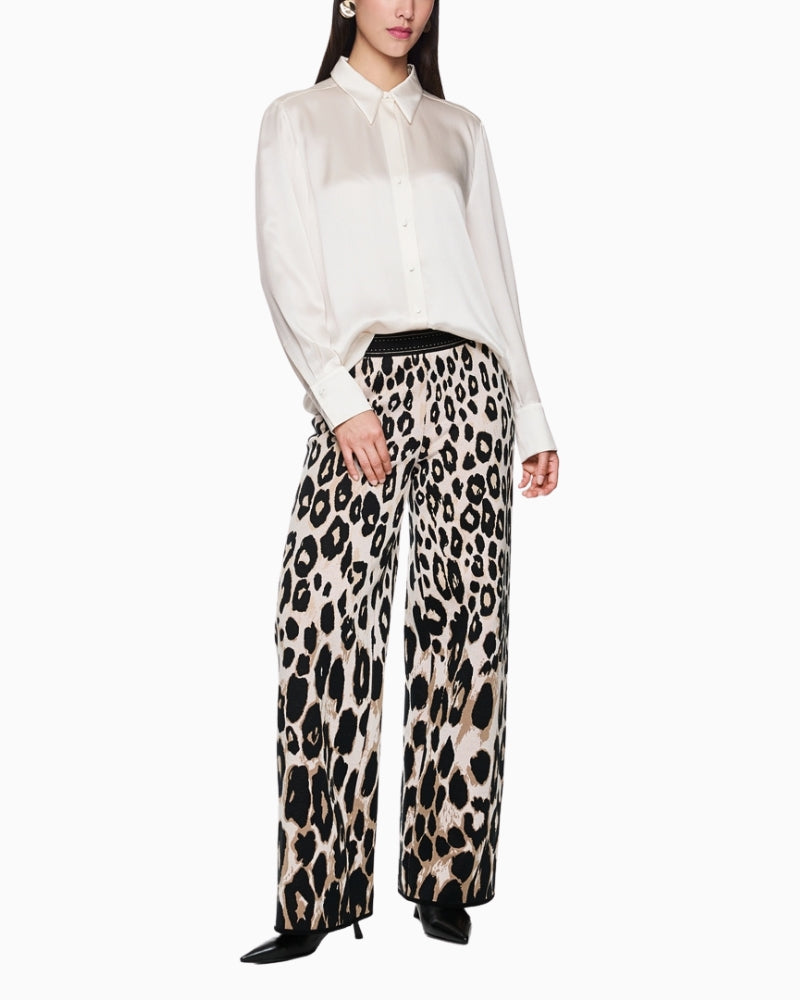 Styled outfit with Marc Cain silk blouse tucked into high-waisted trousers